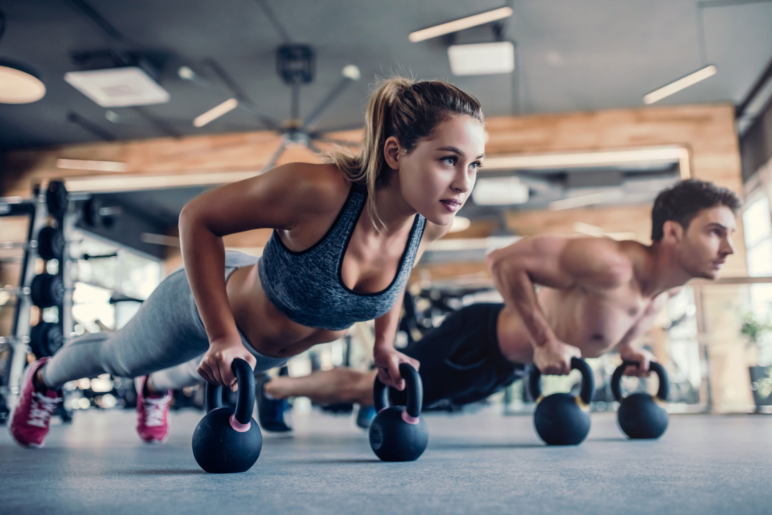 Man and woman doing pushups in the gym